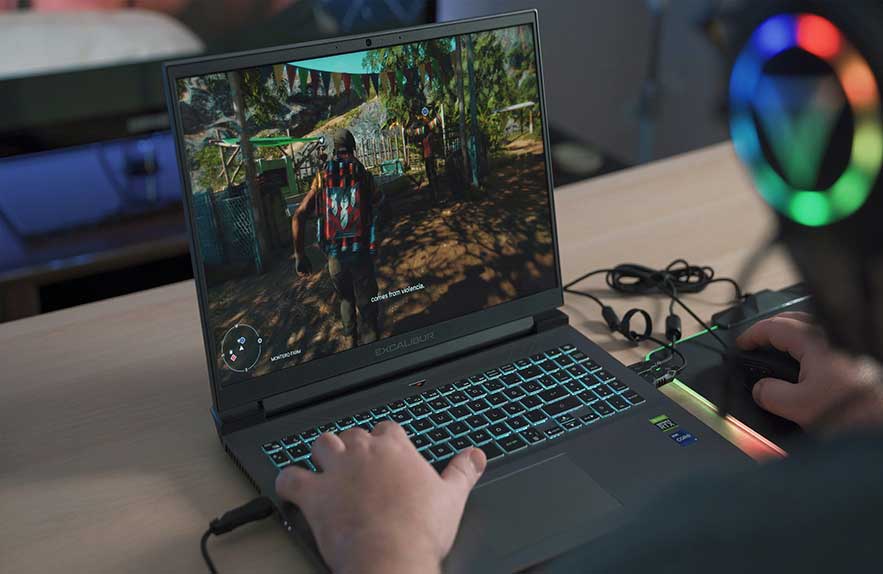 A person playing a game on a powerful gaming laptop, comparing gaming laptop vs desktop performance