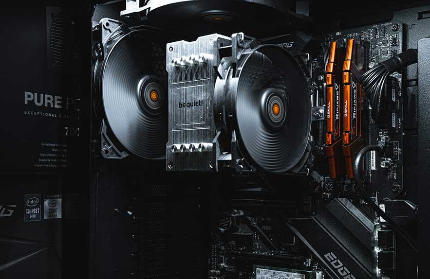 inside view of a computer showing hardware components like CPU cooler and RAM modules to explain what is hardware